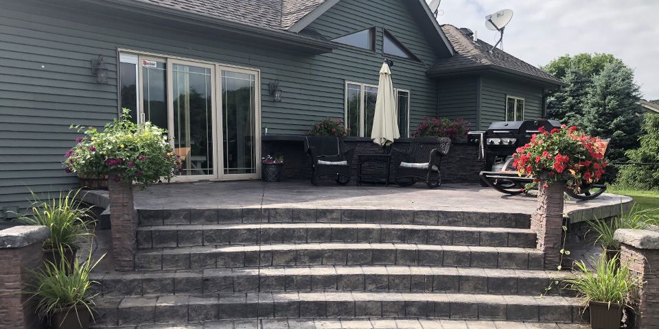 A complete siding replacement transformed this home's exterior while creating a beautiful backdrop for outdoor living. Quality siding not only improves appearance but also protects your home from moisture, wind, and Wisconsin's changing weather conditions. photo